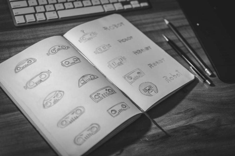 Logo concept sketches in an open notebook